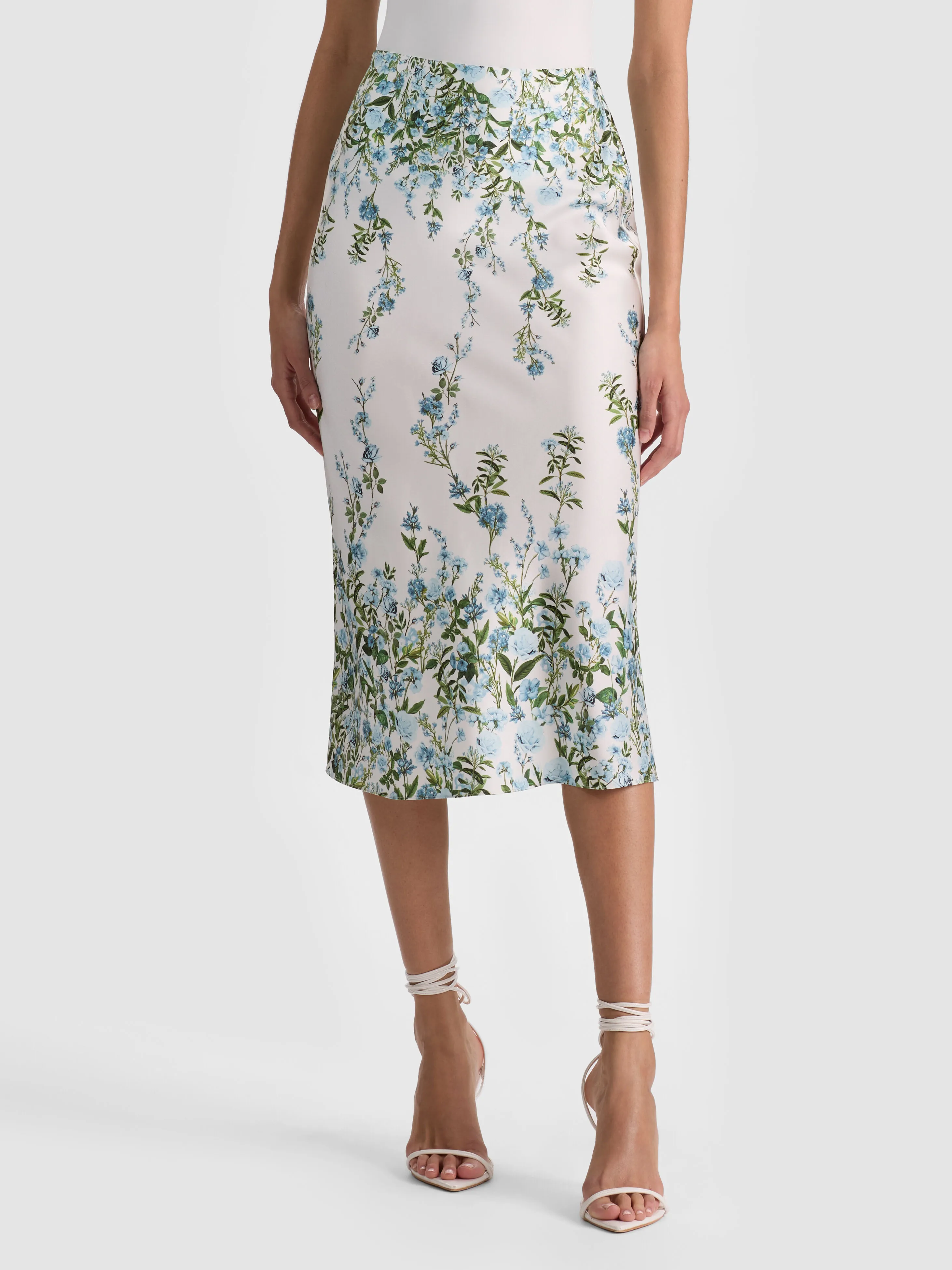 A sleek satin slip skirt draped close to the body, styled with a blazer for a chic day-to-night look