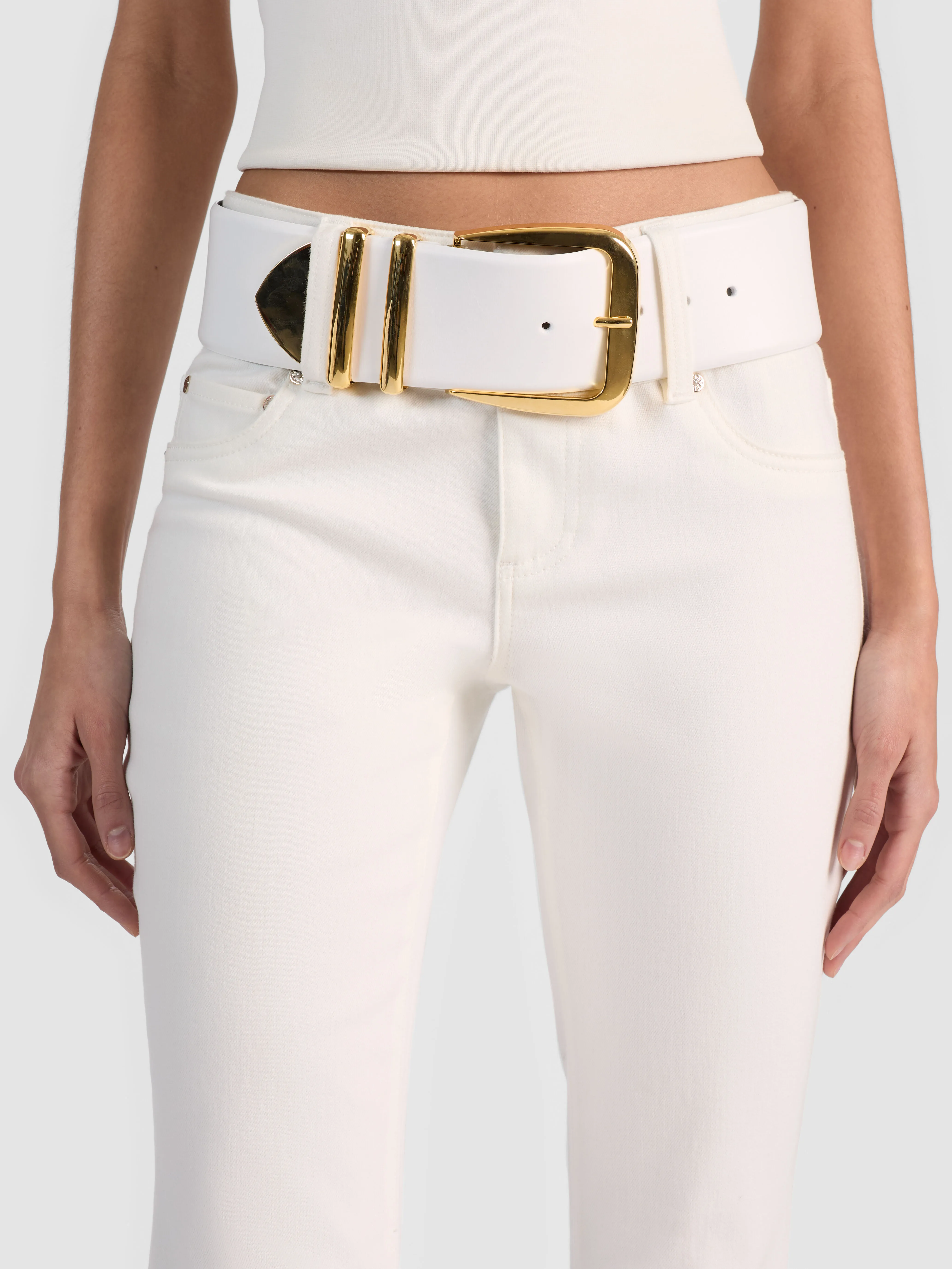 The ALICE + OLIVIA HARLEY WIDE BELT in supple Italian leather with polished gold hardware, styled over a midi dress to define the waist and add instant structure and shine.