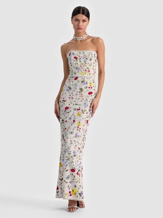A model wearing a flowing maxi dress that reaches the ankles, styled effortlessly for a beach-to-dinner look