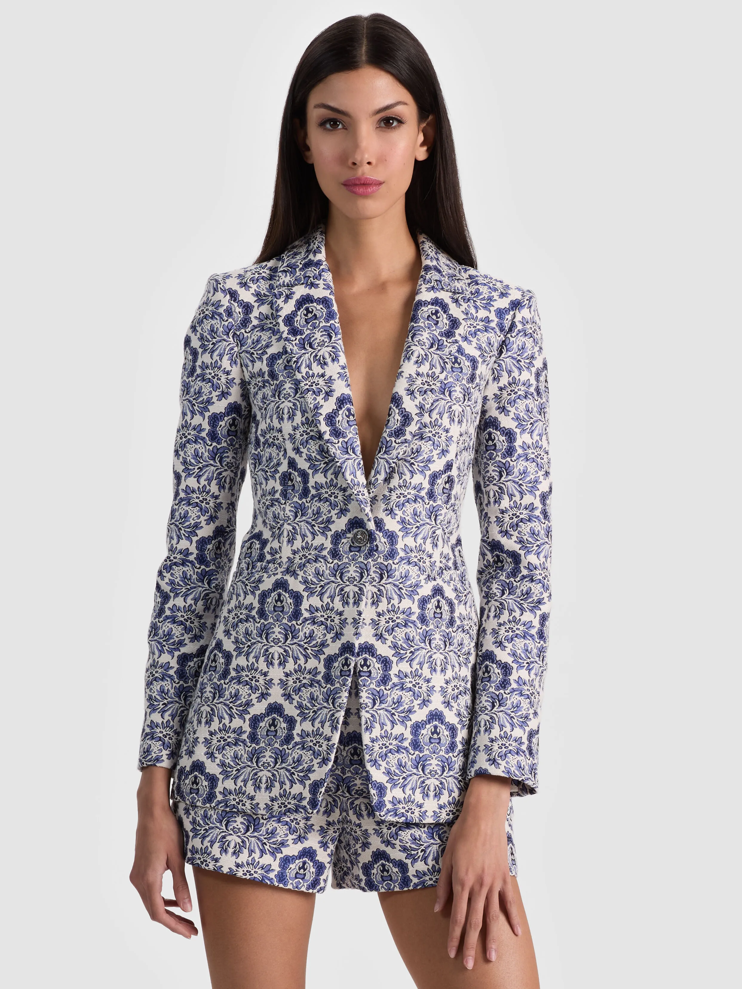 A model wearing the ALICE + OLIVIA Breann Printed Blazer in a damask jacquard, styled as a polished dressy casual look — illustrating elevated dressing done right.