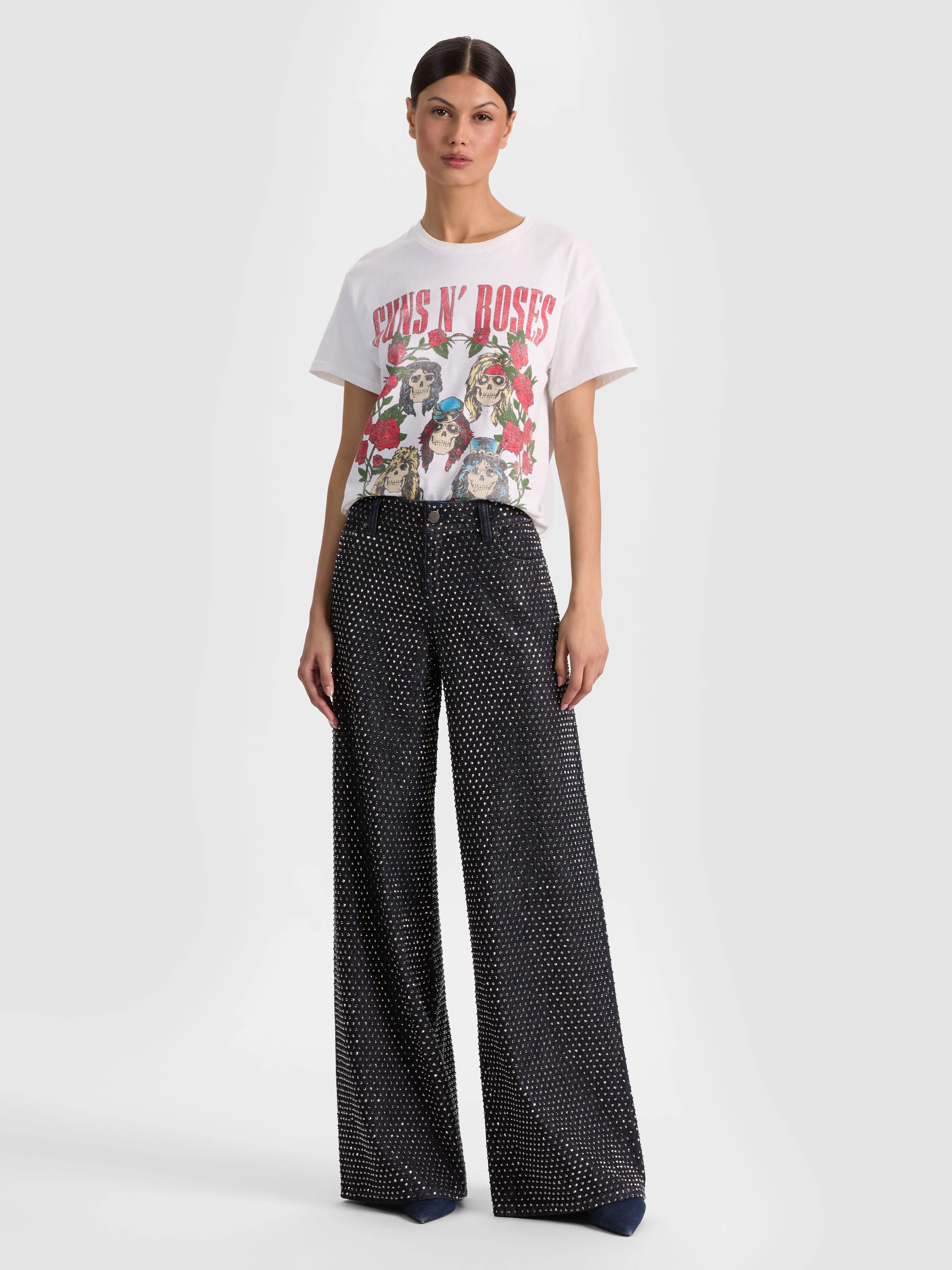 Full-body head-to-toe shot of a model wearing the ALICE + OLIVIA Amazing Embellished Jean in Dark Rinse with a blazer and bodysuit, styled for a sharp and polished workwear look.