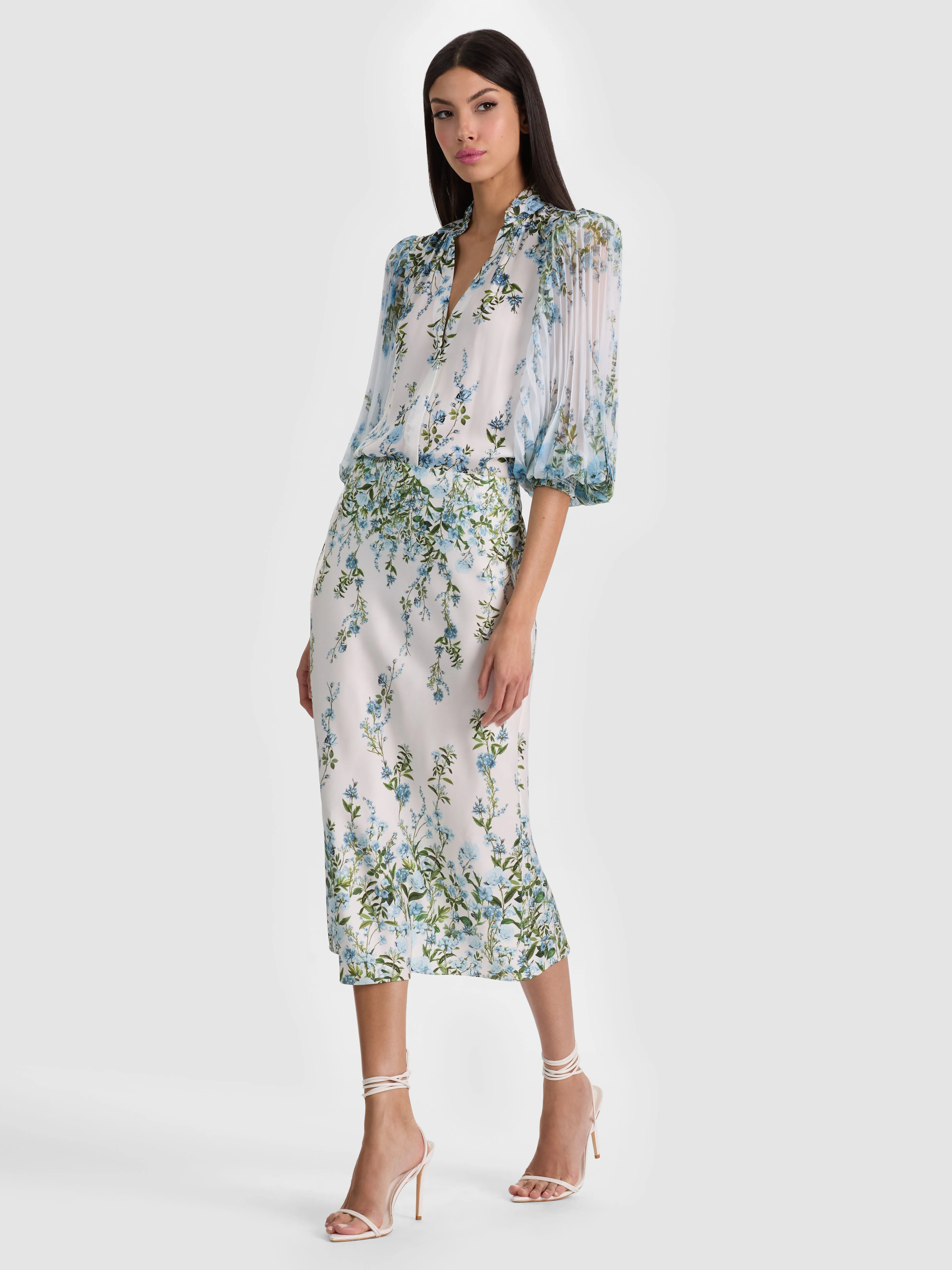 A versatile midi skirt falling between the knee and ankle, styled with heels for a date night look