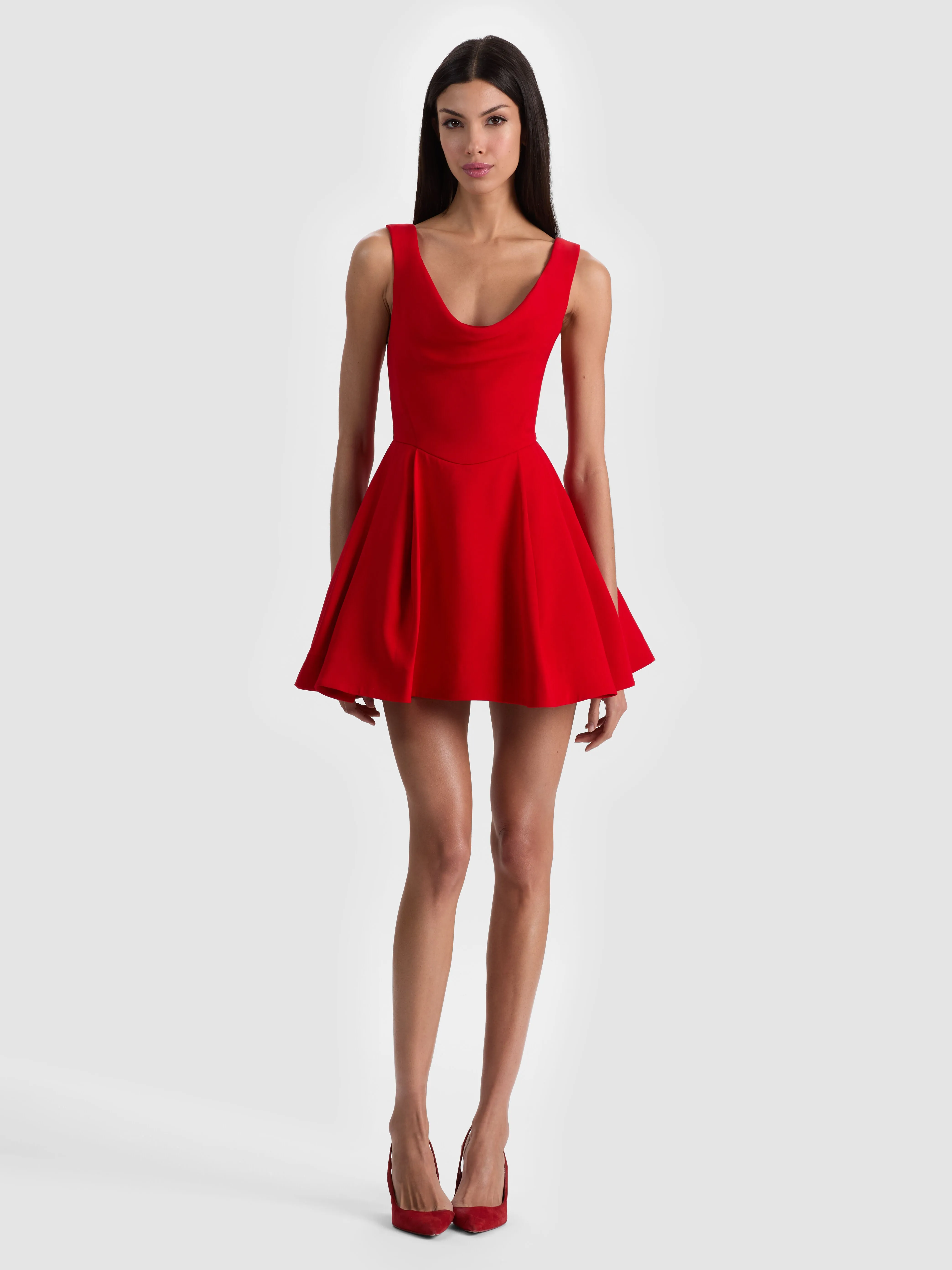 A model wearing a playful fit-and-flare dress fitted through the bodice with a dramatically flared skirt that emphasizes the waist