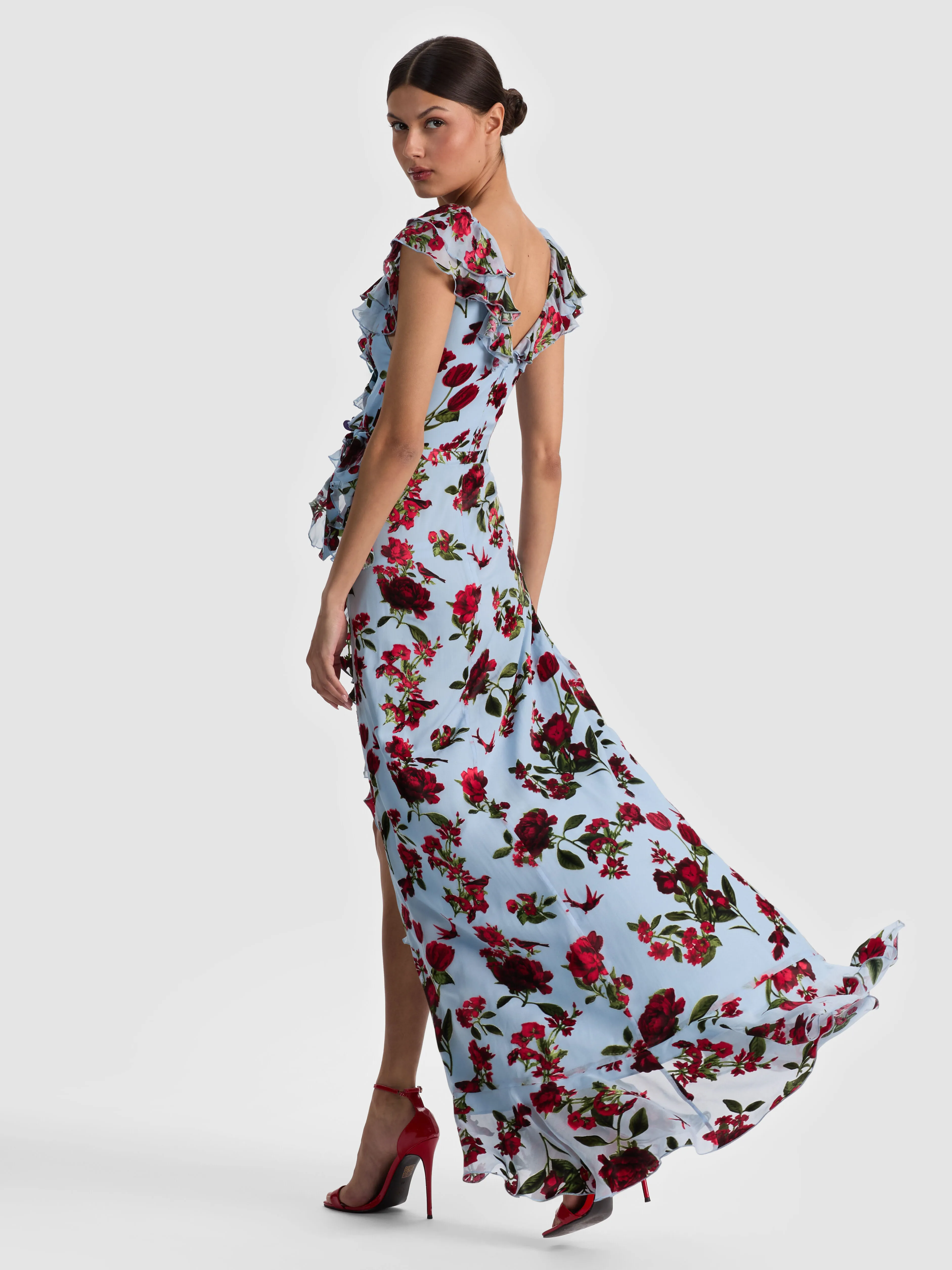 A model wearing a classic wrap dress that crosses over the front and ties at the side, highlighting the waist and bust